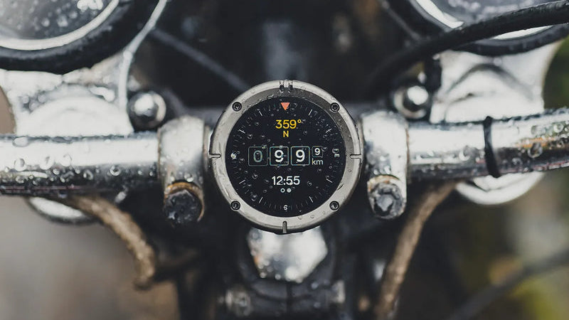 GPS navigation device on a motorcycle handlebar with a blurred background